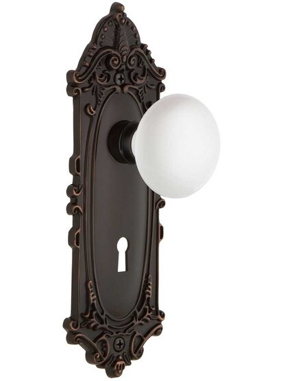 Largo Door Set with White Porcelain Knobs and Keyhole in Timeless Bronze.